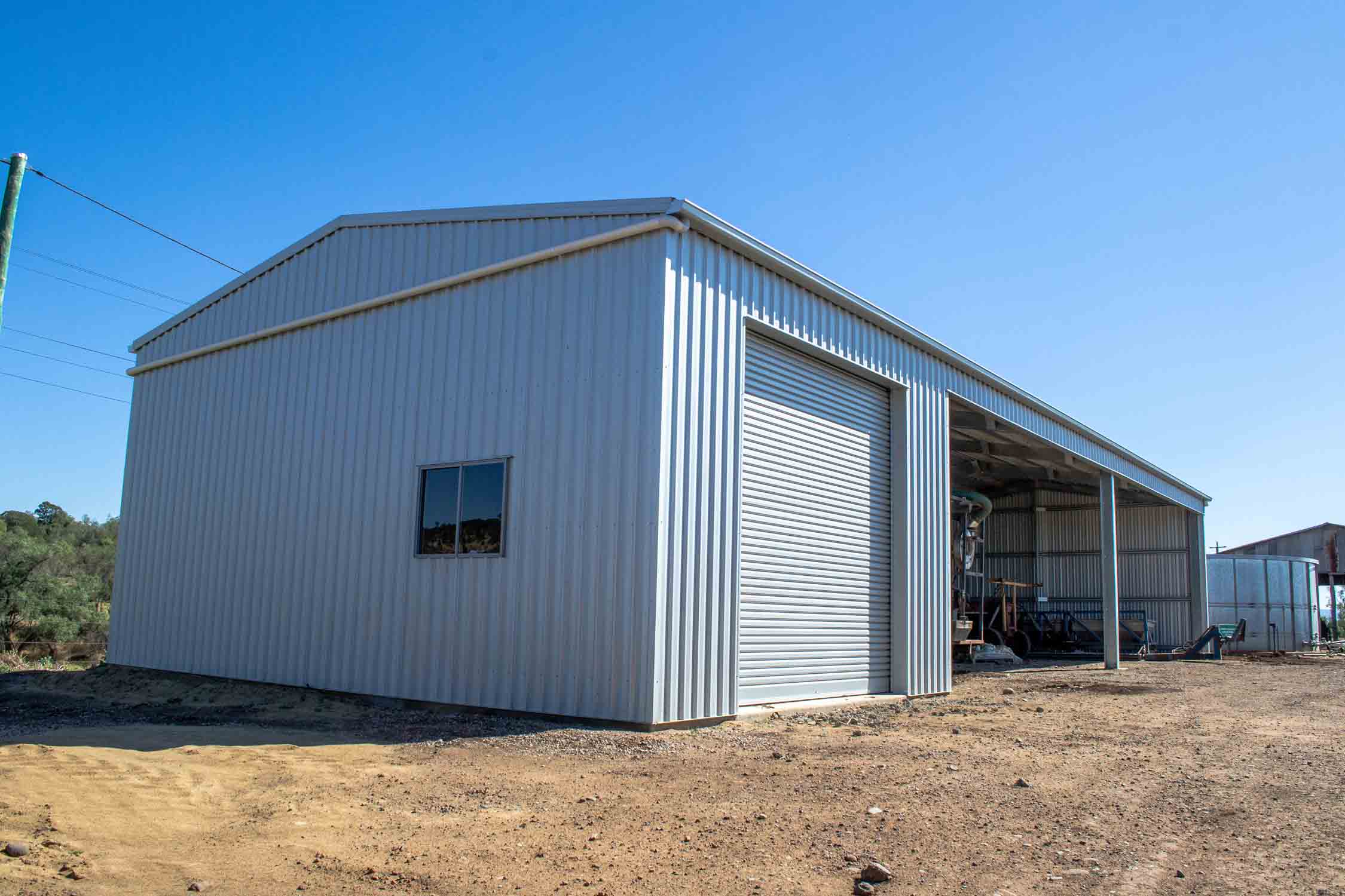 Farm Shed for machinery storage and chemical storage with a lockable bay, secured by a roller door.