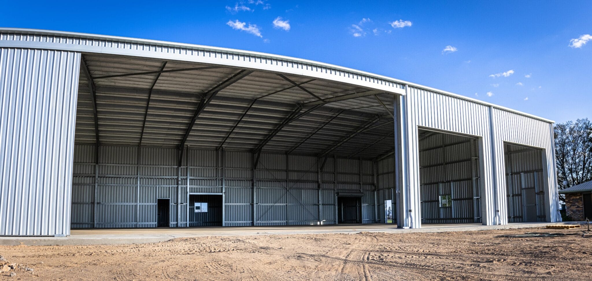 Custom Farm Shed as a Workshop in Gatton, Qld with a 12m wide opening and metal sliding doors, internal walls and a concrete slab.