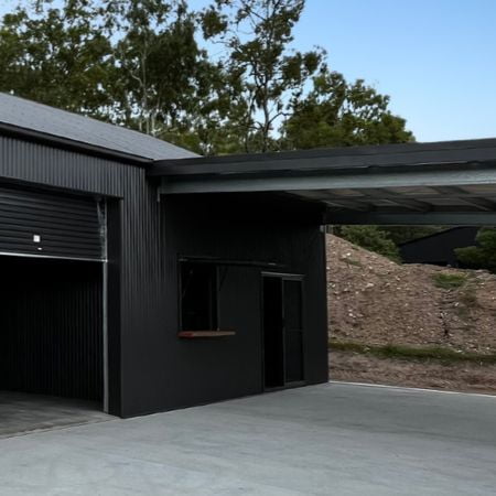 Awning extension off man cave interior with service window and glass sliding door.