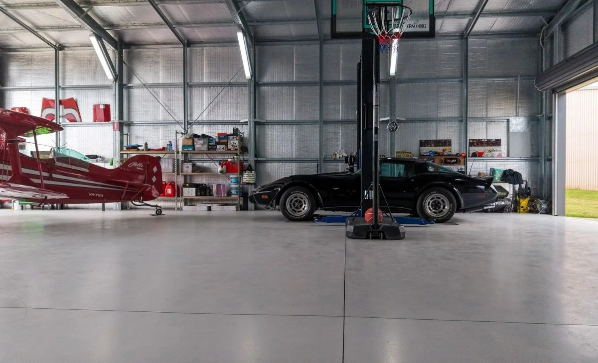Concrete slab with saw-cut joints for a custom aircraft hangar with man cave, built by R&F Steel Buildings Gatton.