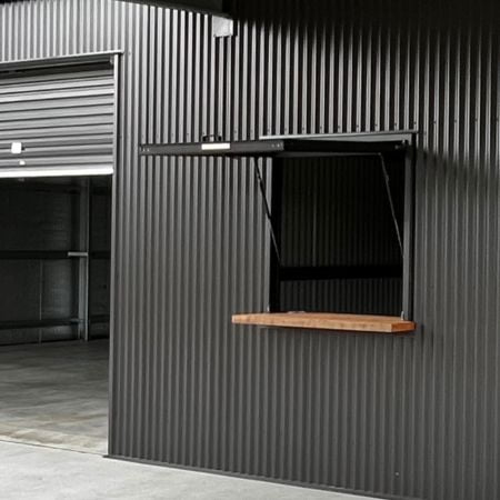 Gas-strut window with timber bench.
