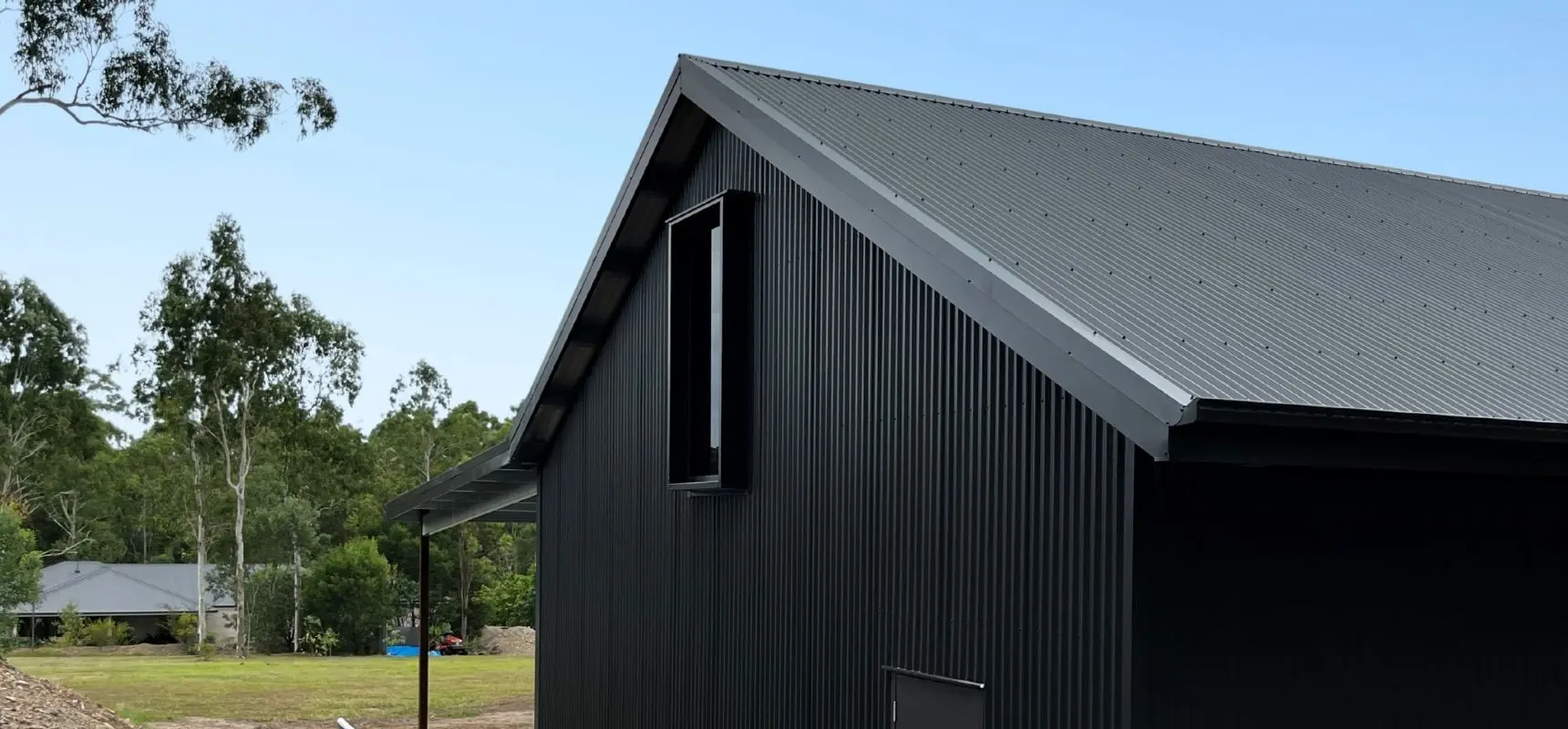 Two bay garage with man cave close up of custom roofline.