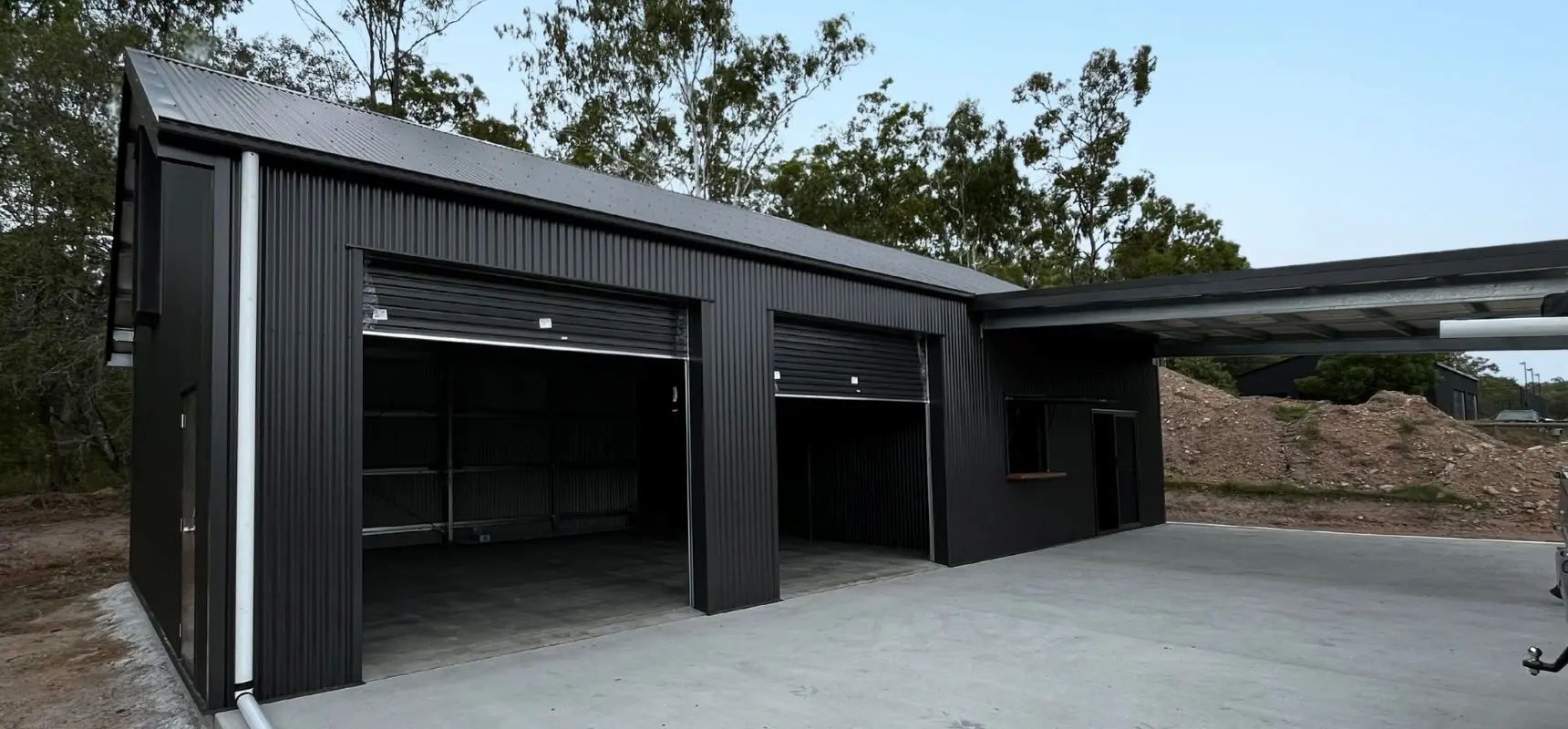 Two bay garage with man cave and 3m wide roller door close up.