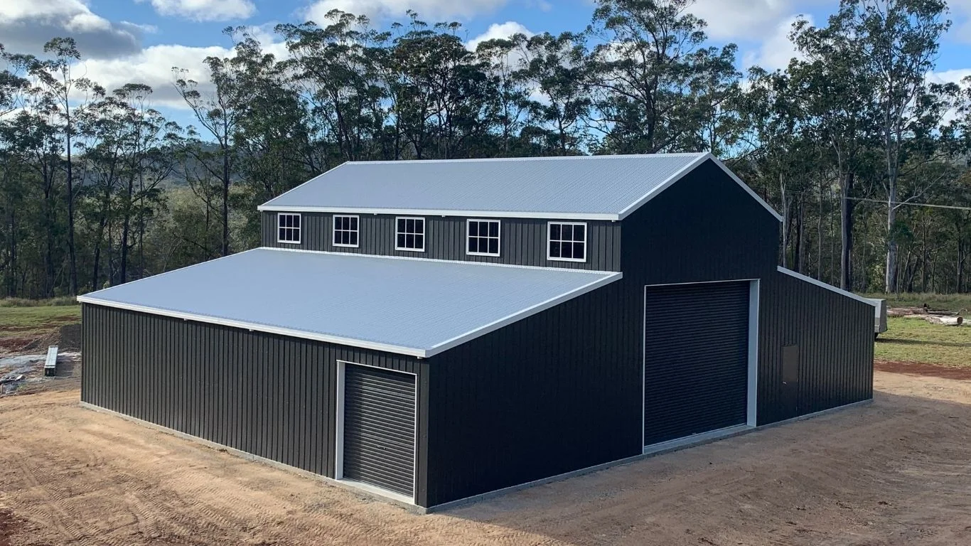 Custom-designed steel American barn shed features a raised central bay and drop-down lean-tos, built on an acreage property by the local R&F Atherton team.