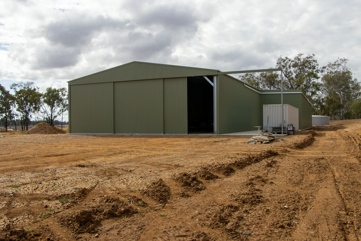 Enclosed workshop area of farm shed with sliding door entry.