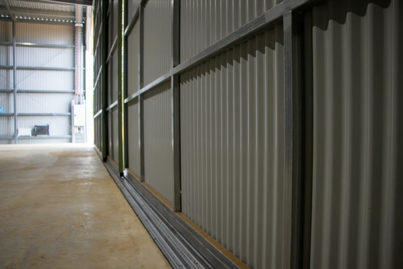 Close-up detail of the steel sliding door assembly