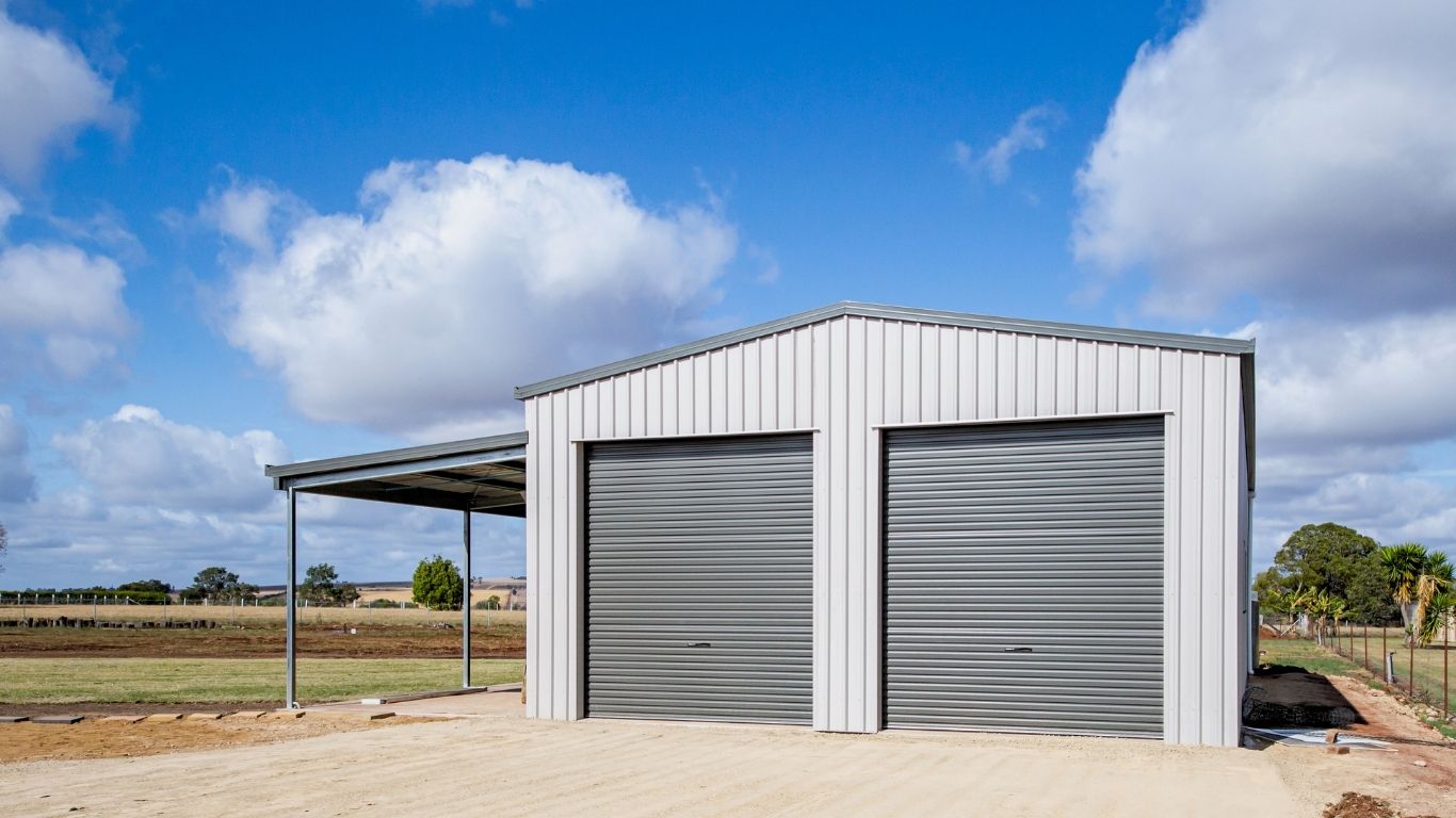 Large steel gable roof shed featuring a custom structural awning extension designed, supplied and built by the local R&F team in Kingaroy.