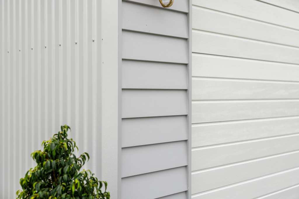 Close-up of James Hardie cladding and panel lift door on a residential custom shed
